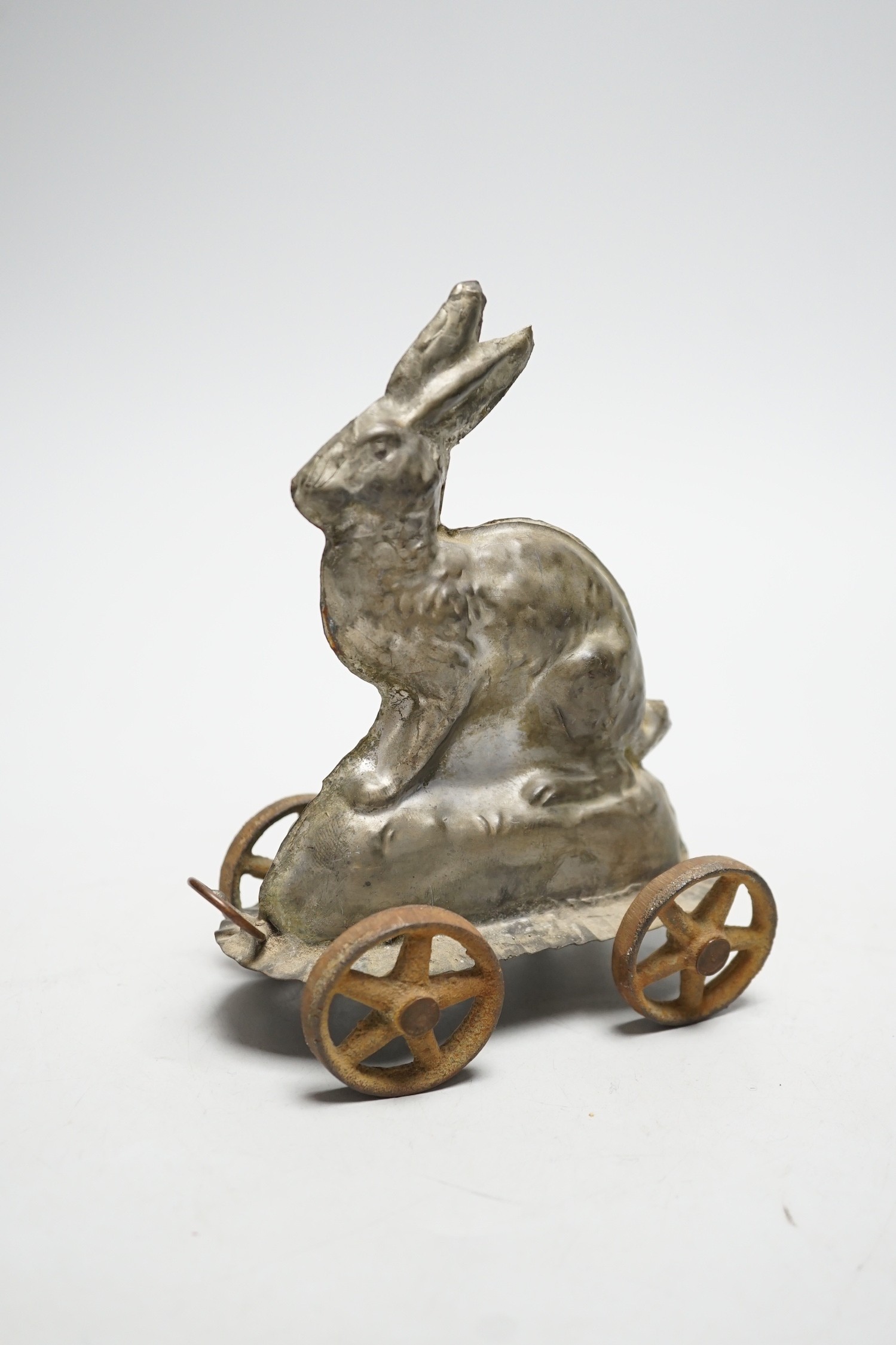A late Victorian / Edwardian confectioners’ rabbit shaped mould, on four wheels, 15cm tall